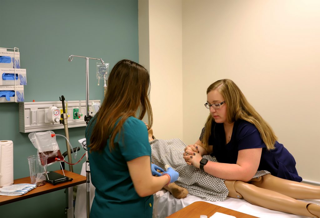 Instructor helping student