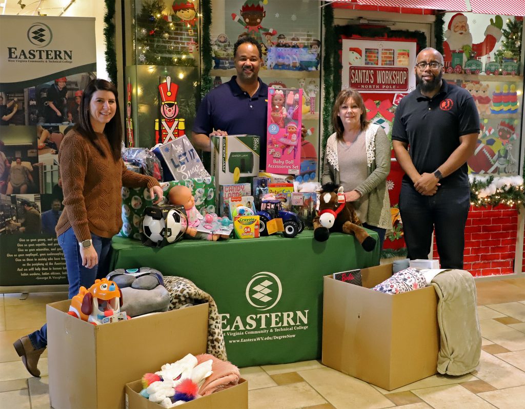 A group of four people displaying toys