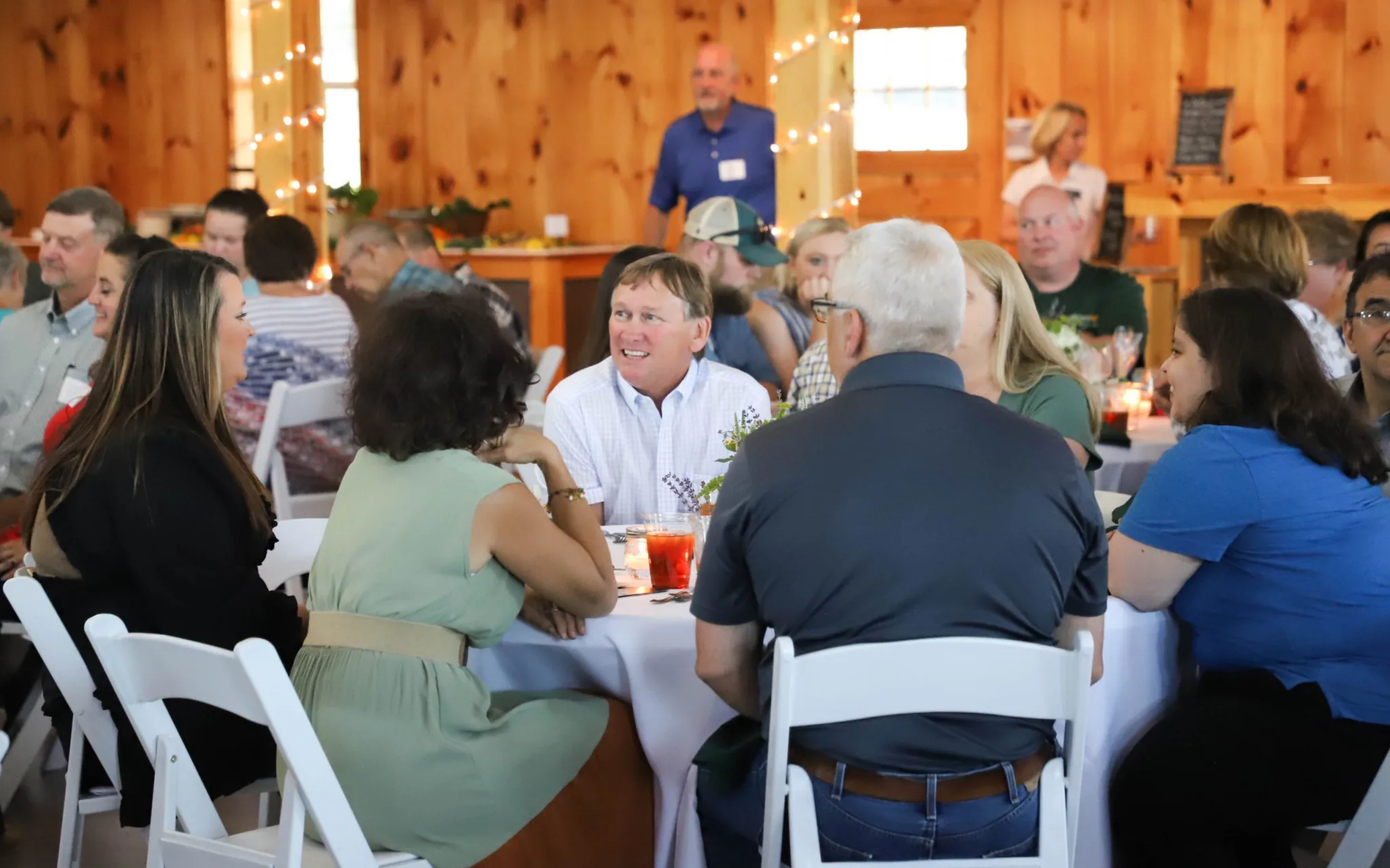 Thomas Striplin, Ed.D. (center), president of Eastern, talks with dinner guests.