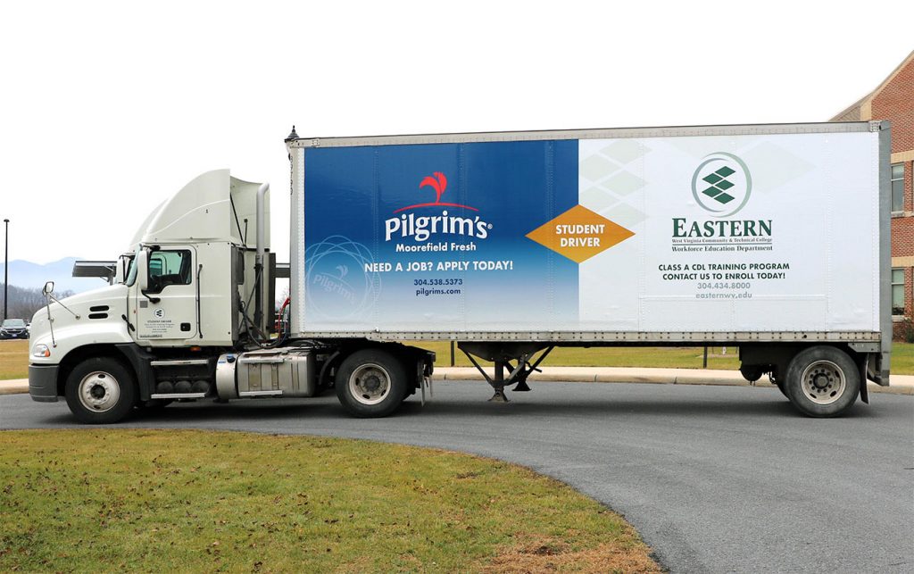 The side view of a tractor trailer.